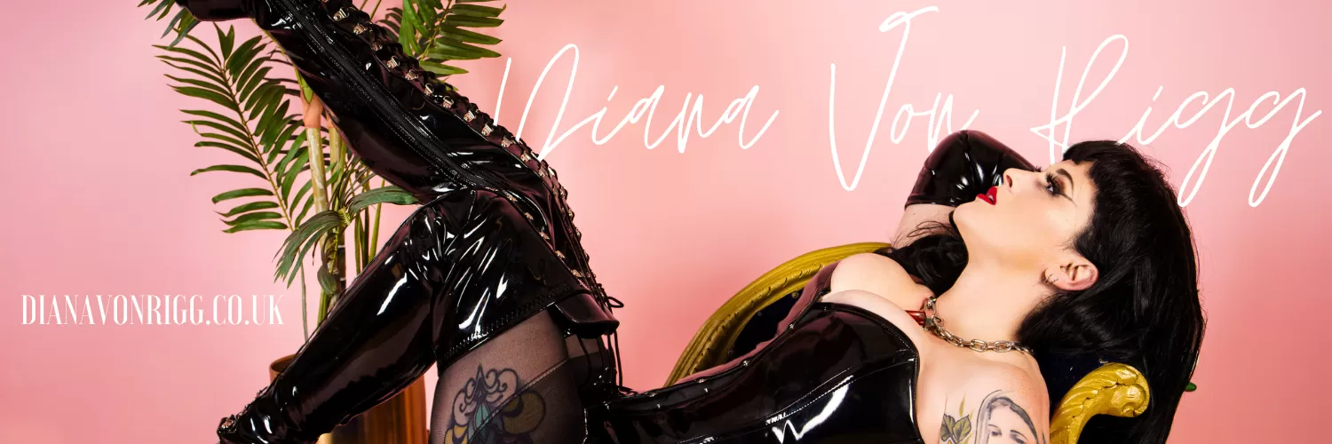 Mistress Diana Von Rigg in a black corset with opera length satin black gloves, looking directly to her right at the logo which says DianaVonRigg.co.uk